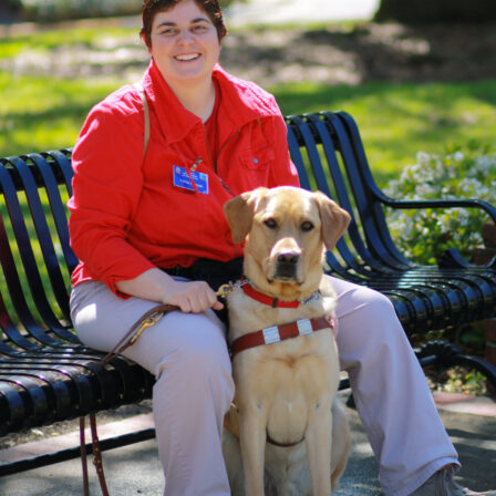 Woman and dog at park bench