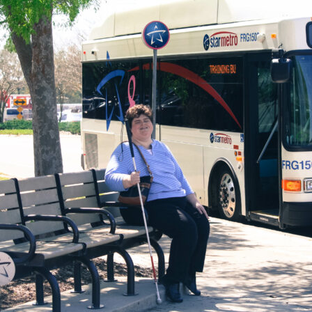 Woman sitting at a bus stop